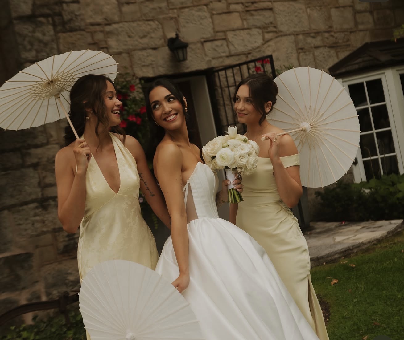 Bride with bridal party holding parasols by AK Artistry